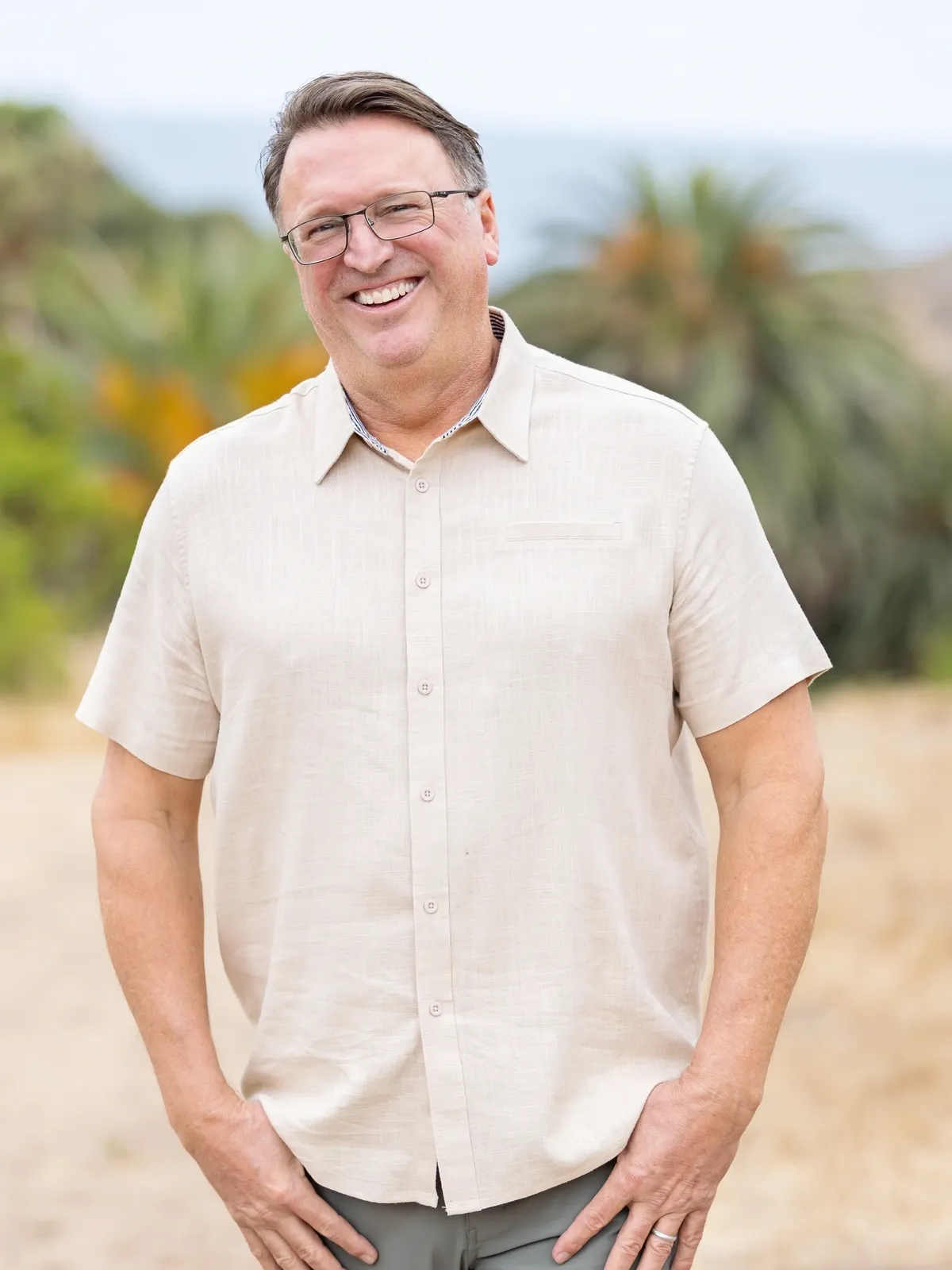 Man in beige shirt outdoors
